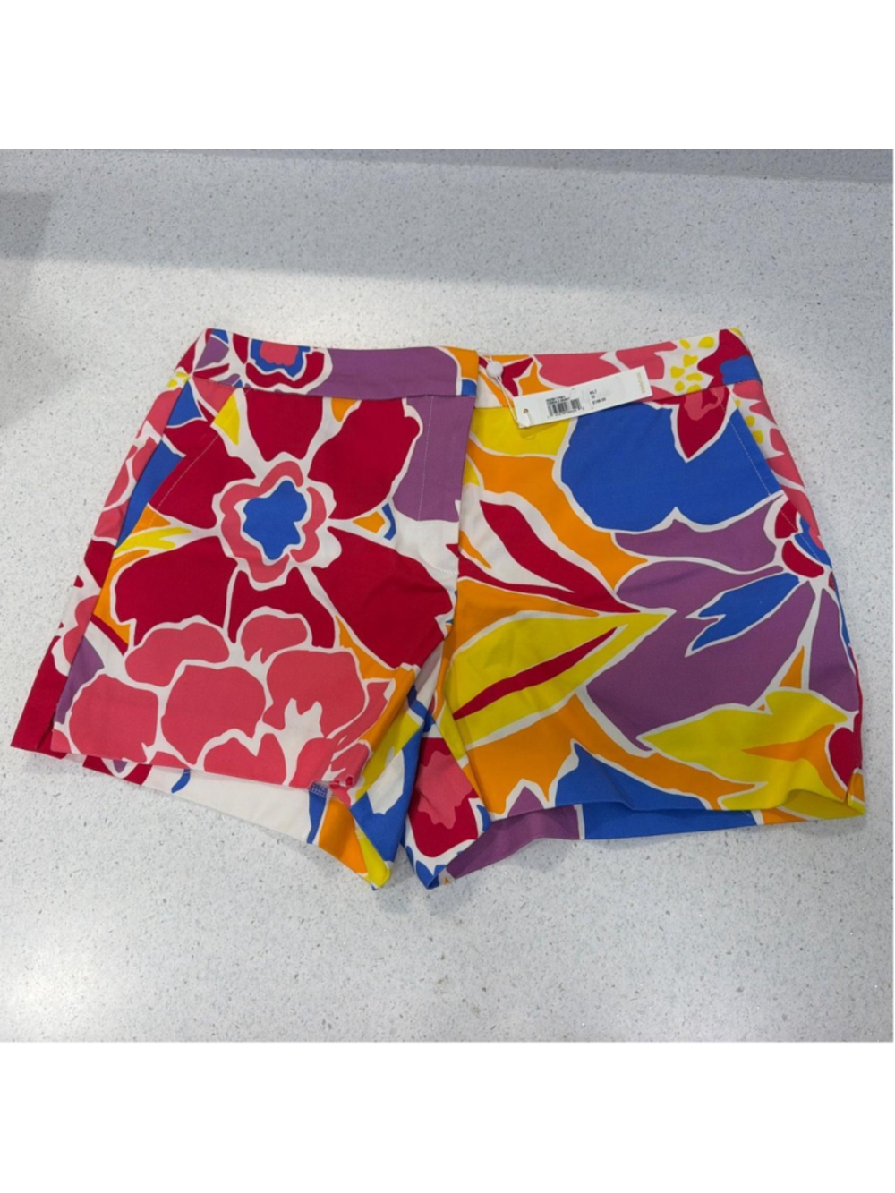Trina Turk floral shorts with red, blue, yellow, and purple flowers, size 10